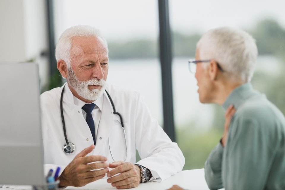 Doctor speaking with a senior patient during a consultation