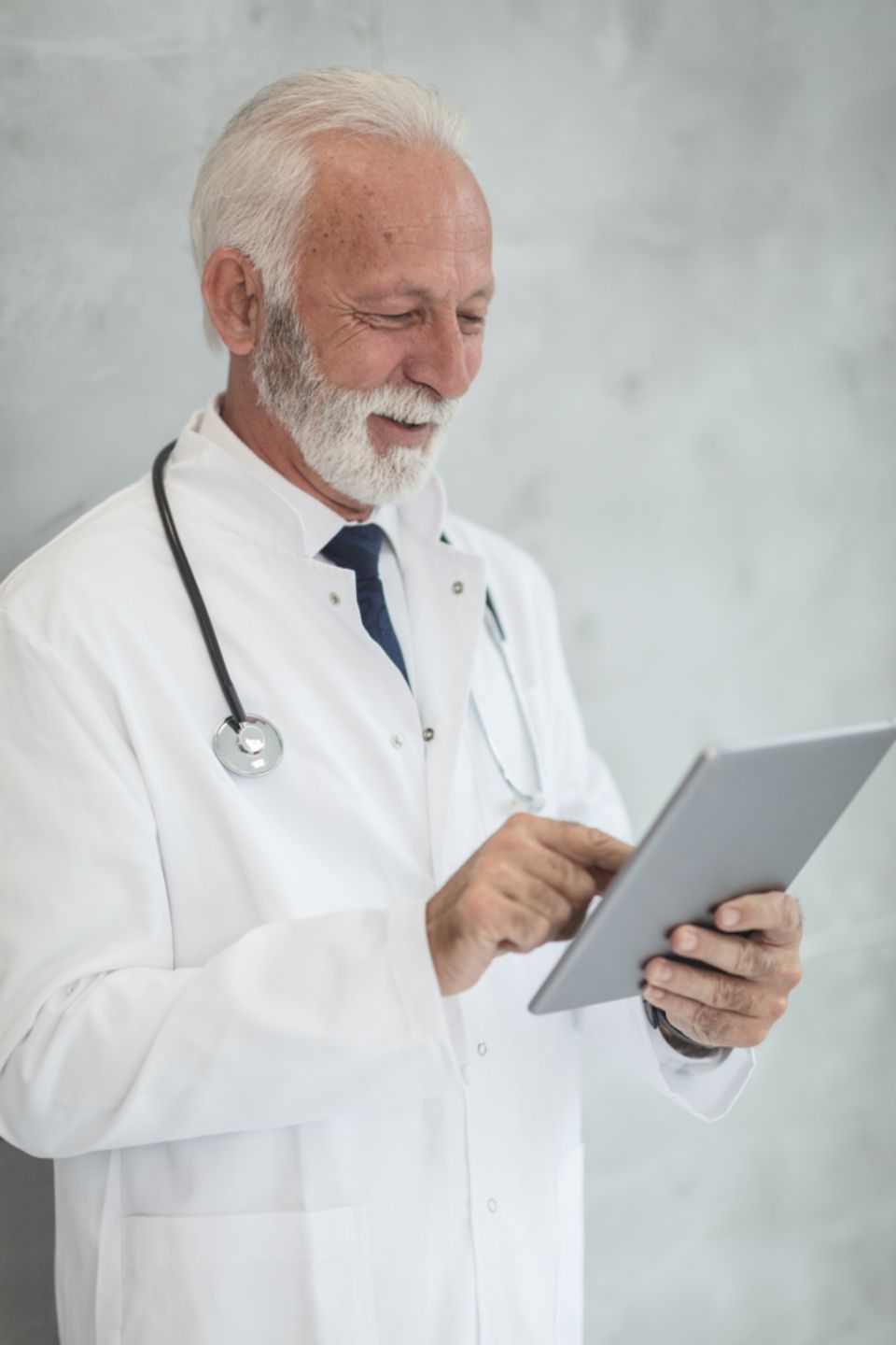 Physician reviewing credentialing information on a tablet