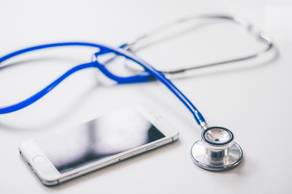 Stethoscope and smartphone on a desk representing prescription coverage
